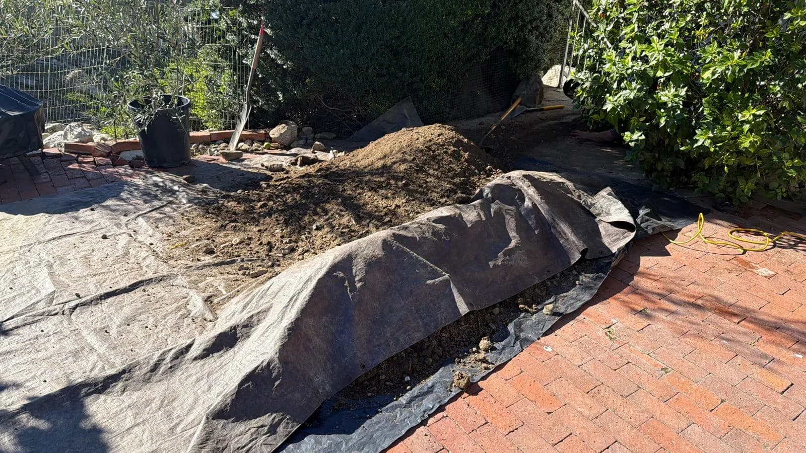 Burbank hillside sewer access before repair – excavation exposing cleanout and sewer entry point