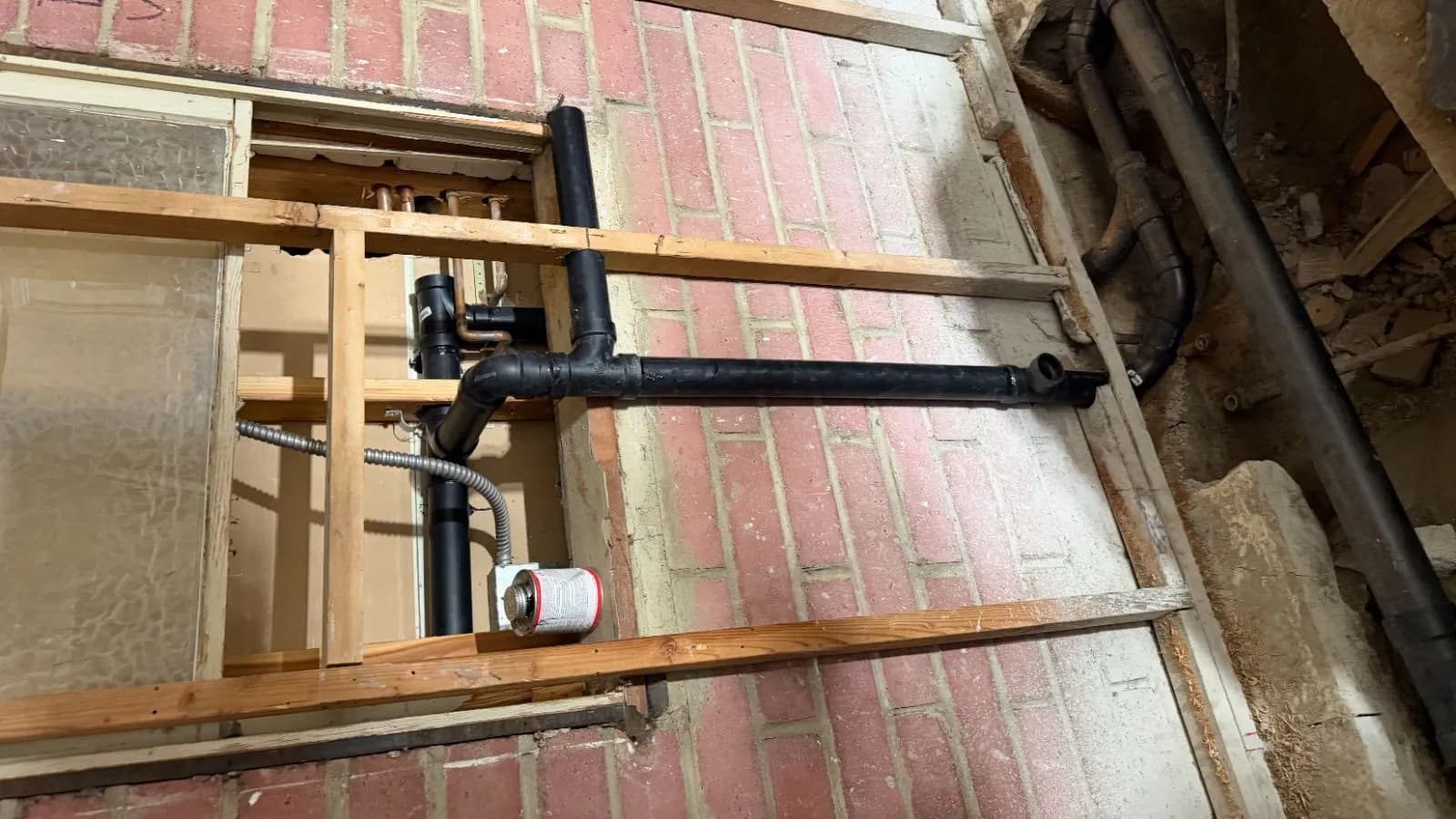 Glendale bathroom rough-in during room conversion – exposed wall showing new drain and vent piping