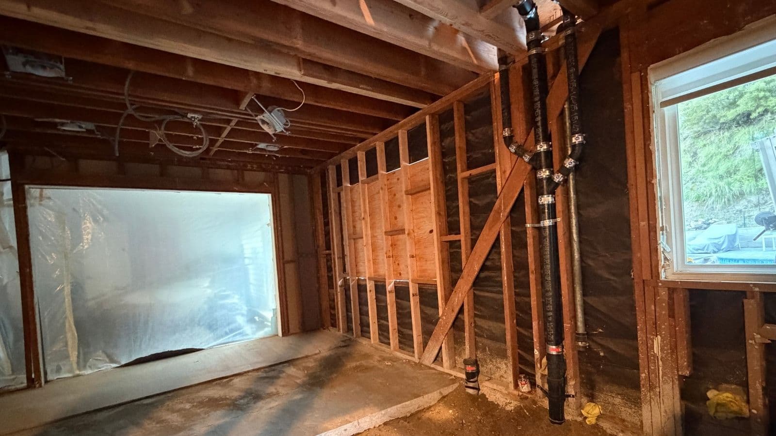 Cast iron vertical sewer stack installed during rough-in plumbing at Glendale home