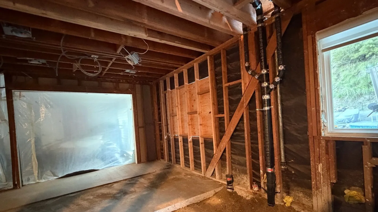 Cast iron vertical sewer stack installed during rough-in plumbing at Glendale home