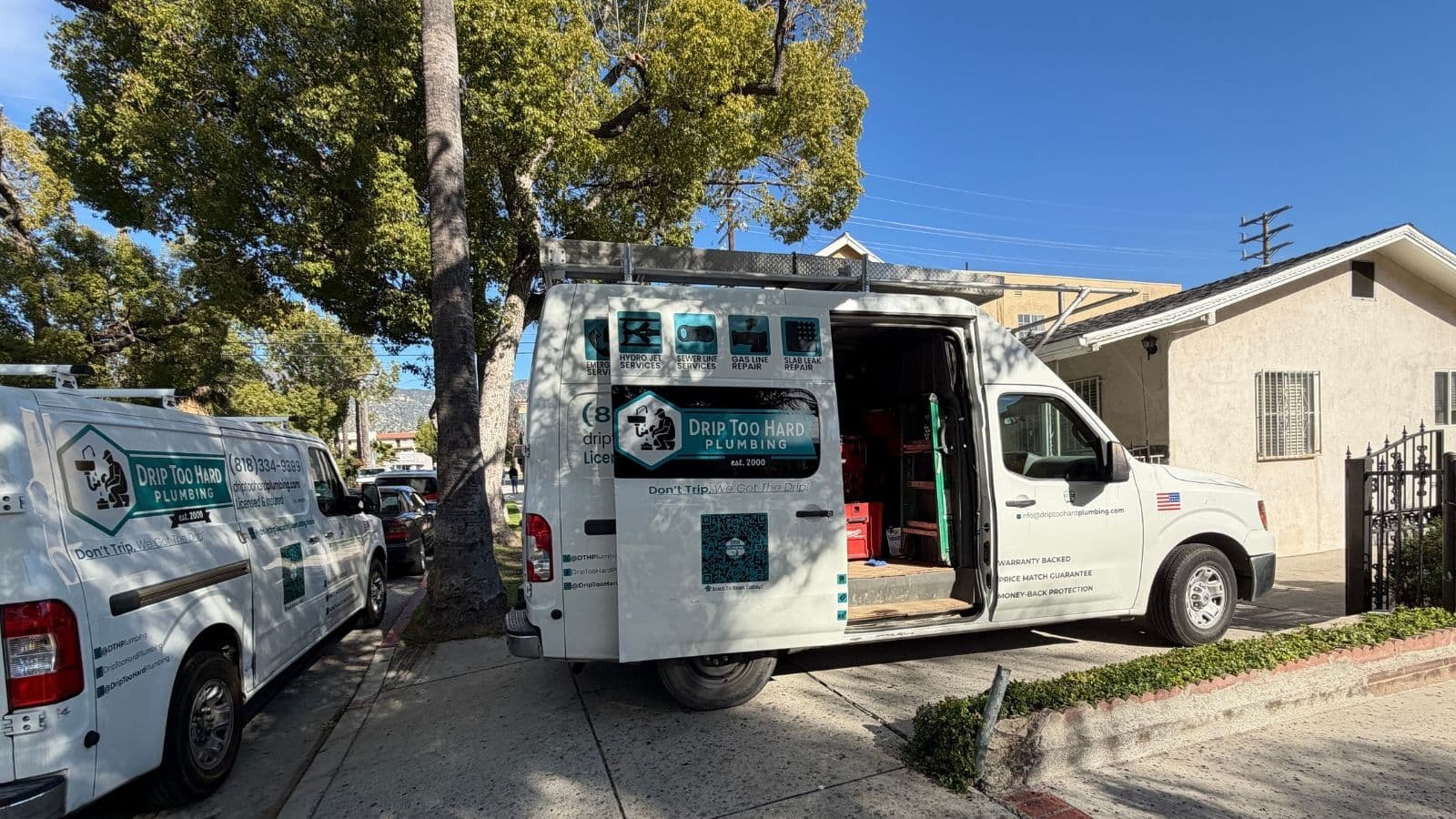 Glendale drain cleaning service with Drip Too Hard Plumbing vans parked near Glenoaks