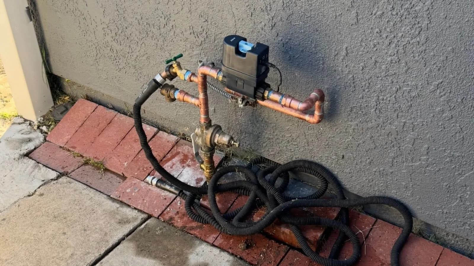 Moen Flo smart water shutoff valve installation on exterior water line in Glendale home