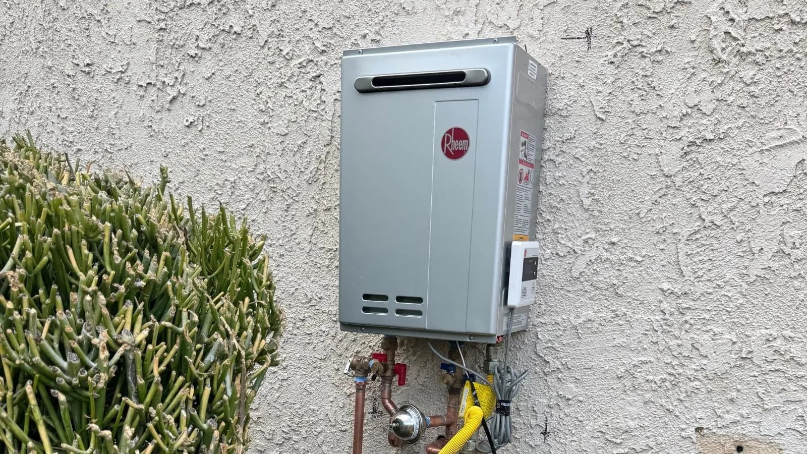 Rheem tankless water heater installation on exterior wall of Glendale home