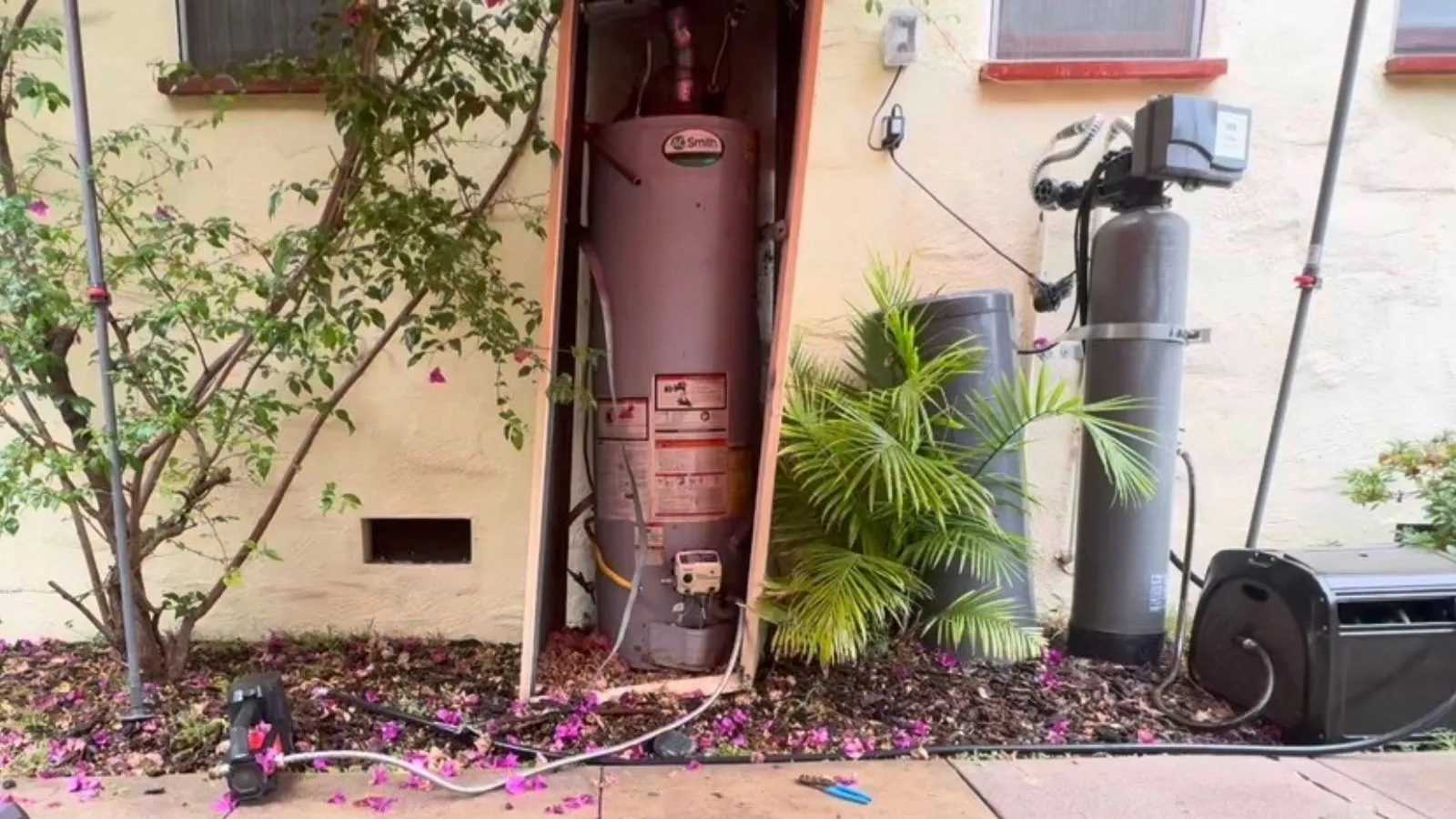 Glendale tank water heater before upgrade – existing tank-style unit installed in exterior enclosure