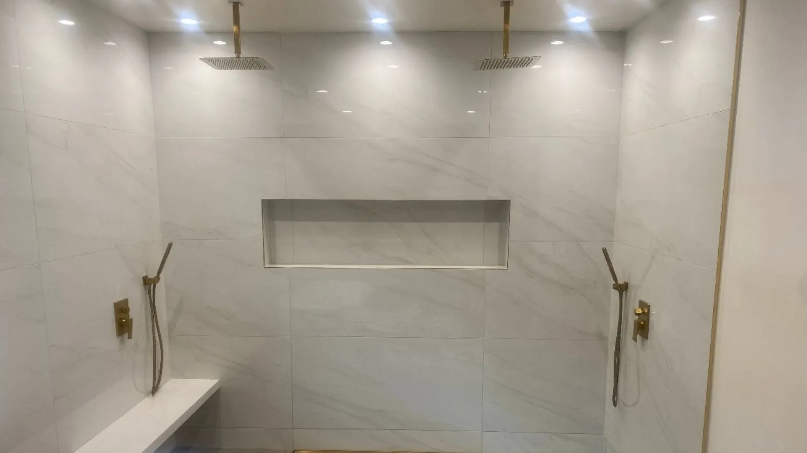 Custom dual shower installation with dual rain showerheads and handheld fixtures in La Cañada bathroom