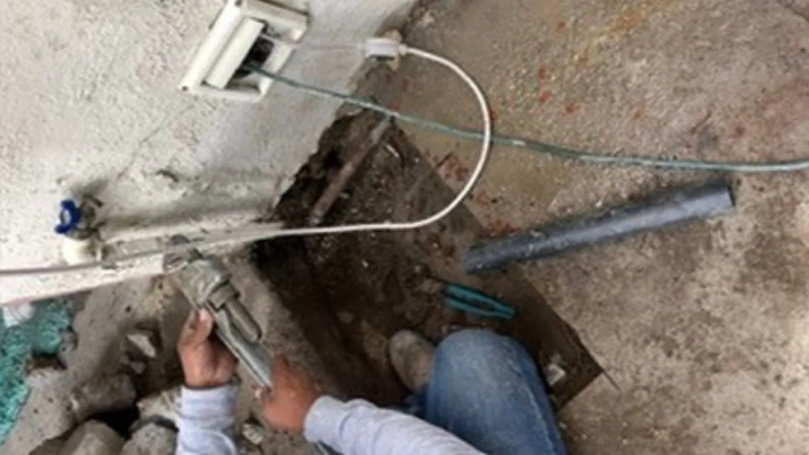 La Crescenta water service line before repair – exposed piping and excavation near the home