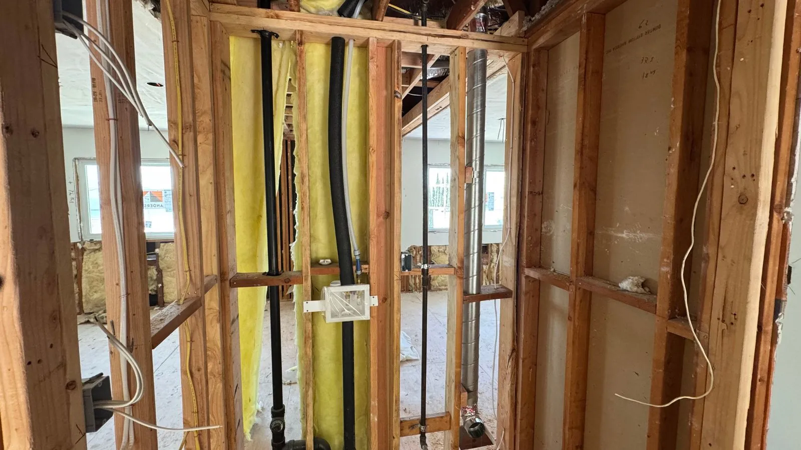 La Crescenta new construction plumbing – bathroom and utility rough-in with exposed studs and piping