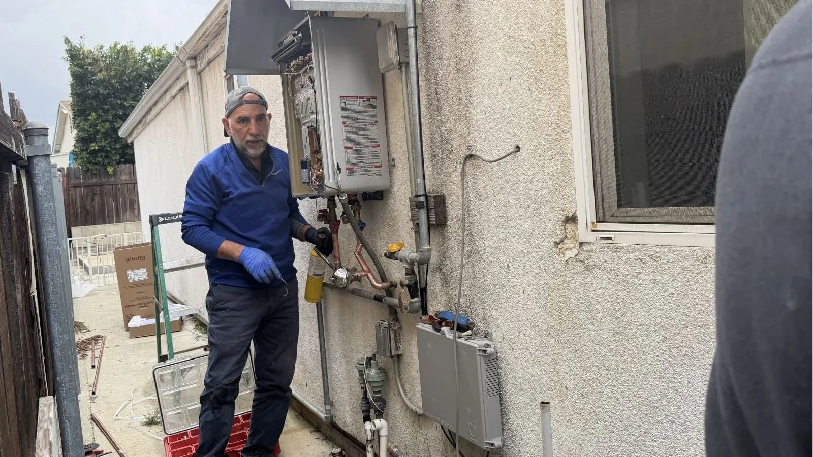 New tankless water heater installed on exterior wall in Tujunga, CA