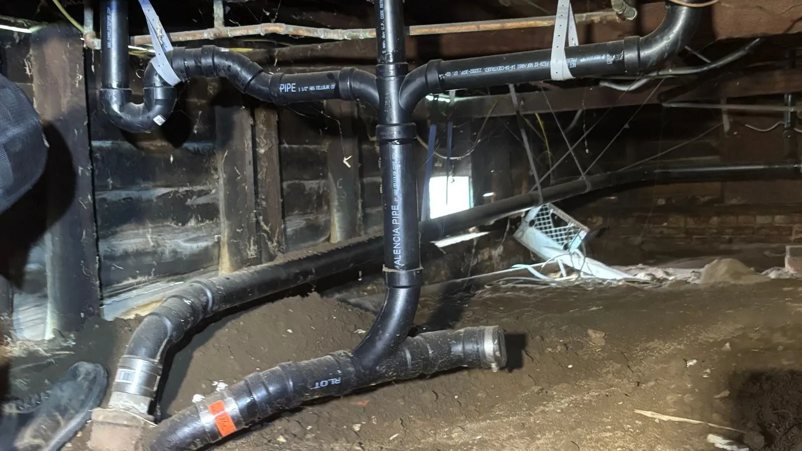 Underground drain repair with new ABS piping installed beneath home in Tujunga