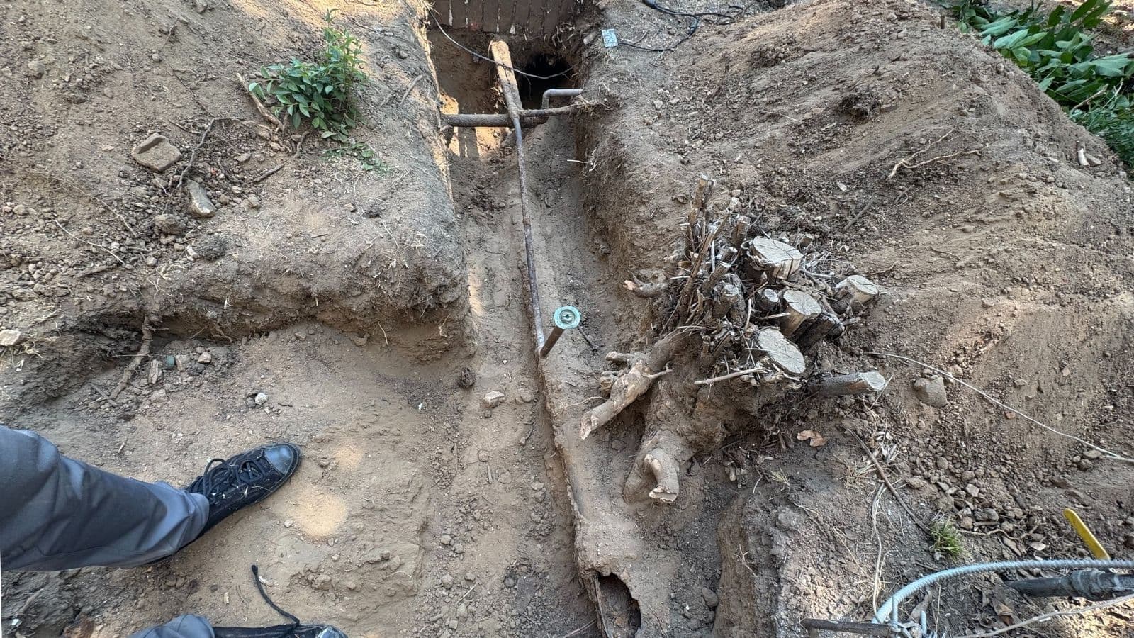 Exposed damaged sewer line before replacement at Altadena home